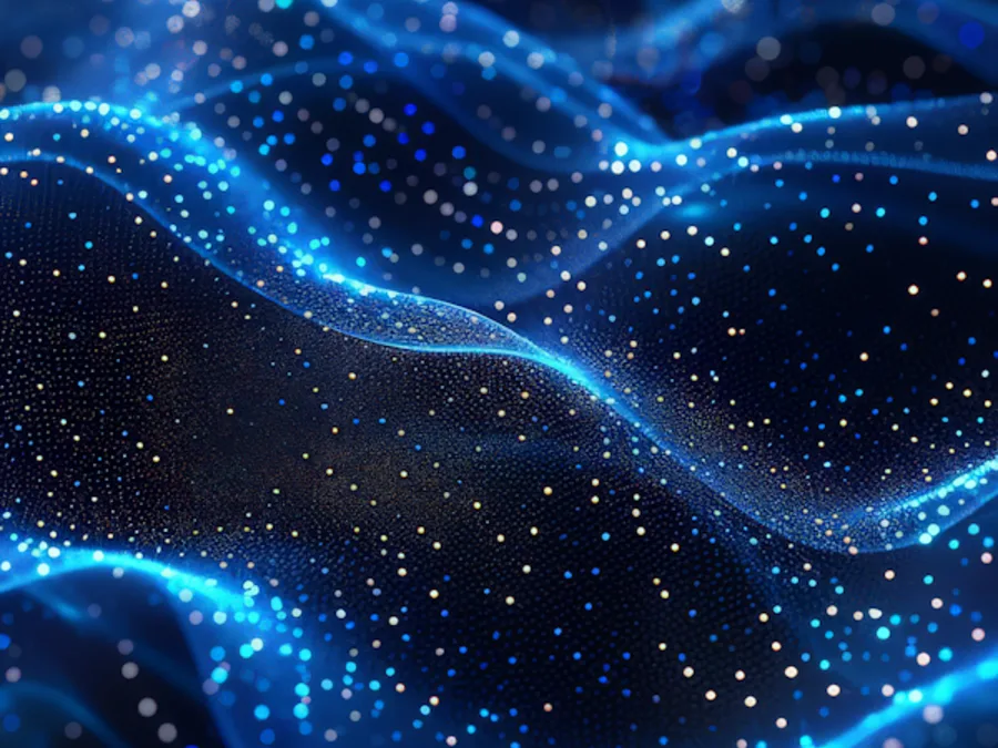 Vagues de particules bleues lumineuses, image des flux de données qui traversent les canaux de sortie